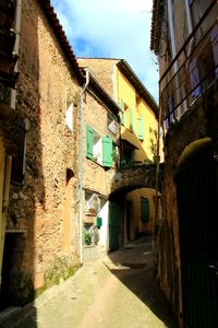 Narrow street amidst buildings in city