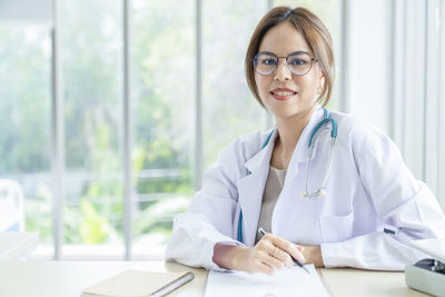 Portrait of young businesswoman working in office