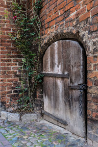 Close-up of door on brick wall