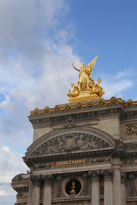 Low angle view of statue against cloudy sky