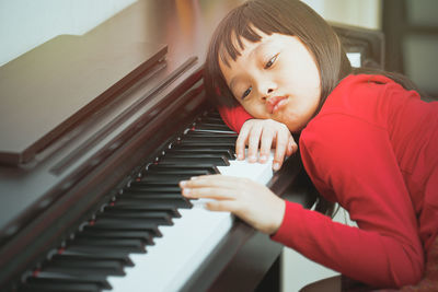 Boy playing piano at home
