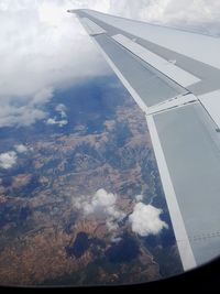 Aerial view of airplane wing over landscape