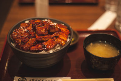 Close-up of food served in bowl on tray over table