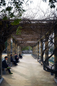 People walking on walkway amidst buildings