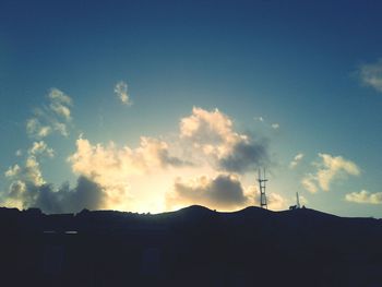 Low angle view of silhouette house against sky during sunset