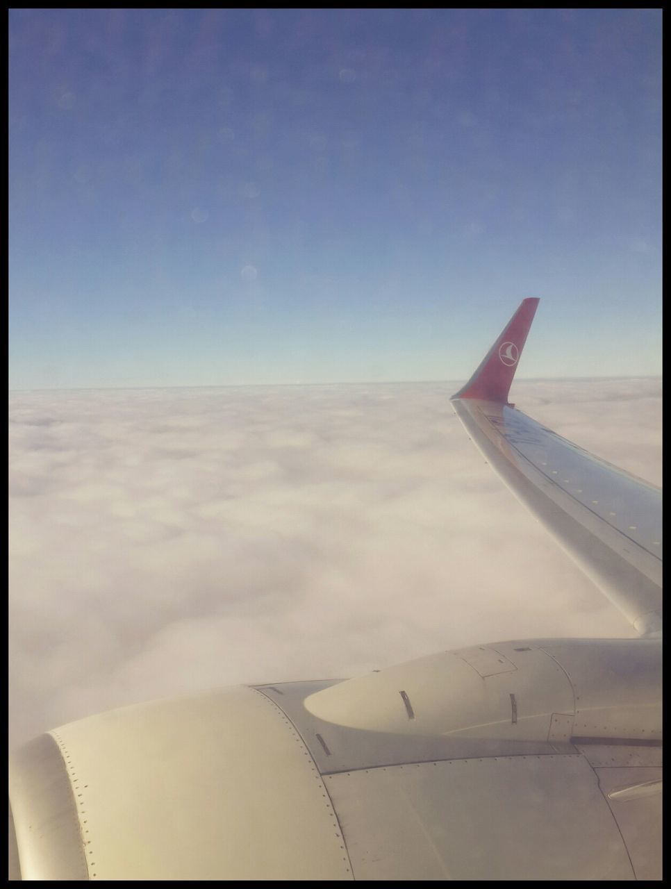 airplane, air vehicle, aircraft wing, transfer print, part of, cropped, flying, transportation, sky, auto post production filter, mode of transport, aerial view, mid-air, travel, day, cloud - sky, clear sky, nature, no people, outdoors