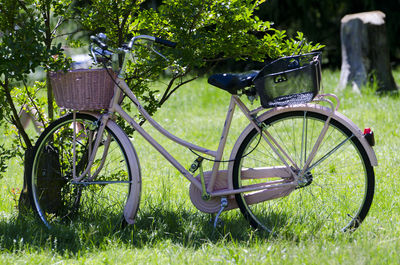 Bicycle parked on grassy field at park