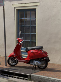 Motorcycle parked on sidewalk in city