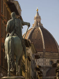 Statue of historic building against sky