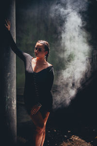 Full length of young woman standing in abandoned house