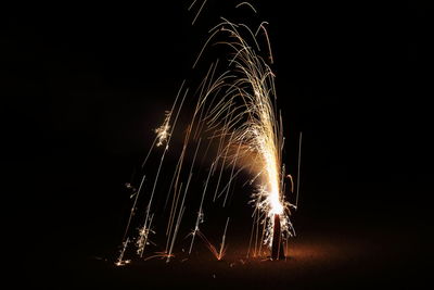 Low angle view of firework display at night