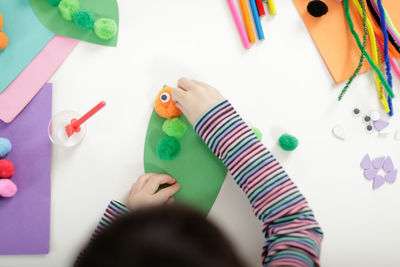 High angle view of person playing with toy