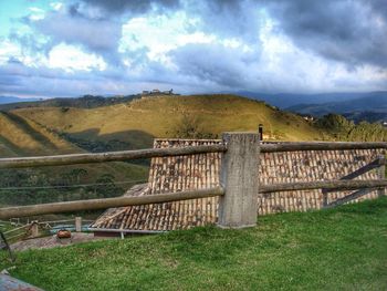 Scenic view of mountains against cloudy sky