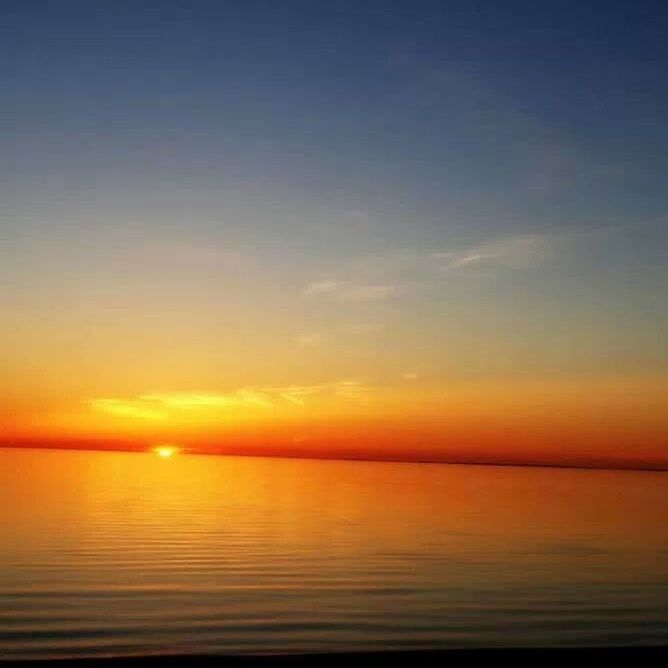 sea, sunset, water, horizon over water, tranquil scene, scenics, tranquility, beauty in nature, orange color, sky, idyllic, nature, beach, reflection, shore, calm, outdoors, remote, copy space, seascape