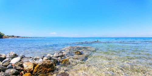 Scenic view of sea against blue sky