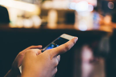 Close-up side view of hands text messaging