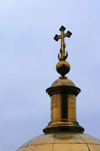 Low angle view of weather vane against clear sky