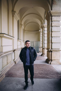 Full length of young man standing in building