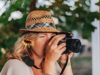 Midsection of woman holding camera