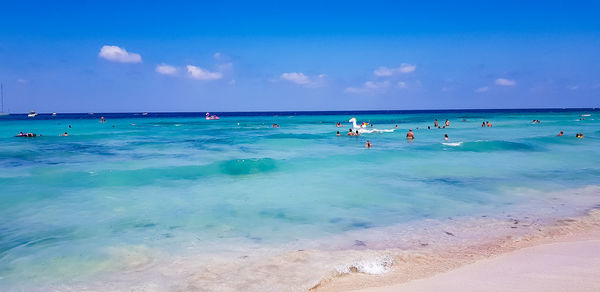 Scenic view of beach against blue sky