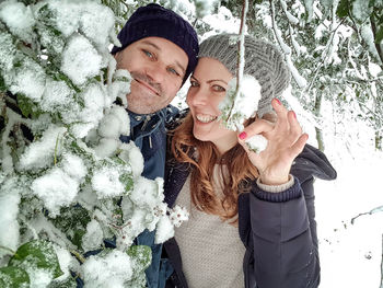 Portrait of smiling young couple holding