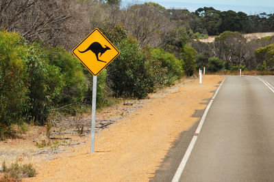 Road sign by trees