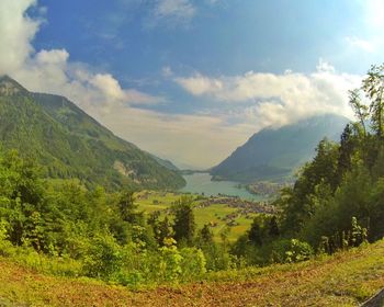 Scenic view of landscape against cloudy sky