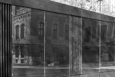 Abandoned building seen through wet glass window