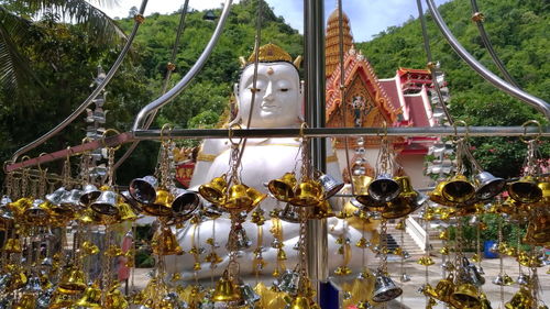 Low angle view of statue hanging against trees