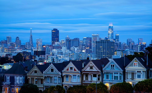 Buildings in city against blue sky