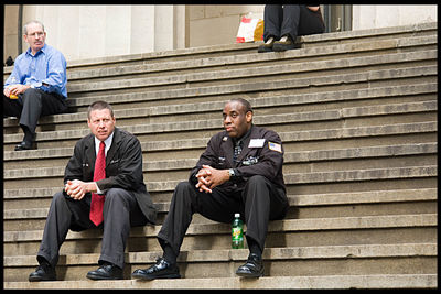 Portrait of friends sitting on staircase in city