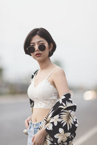 Young woman wearing sunglasses standing outdoors