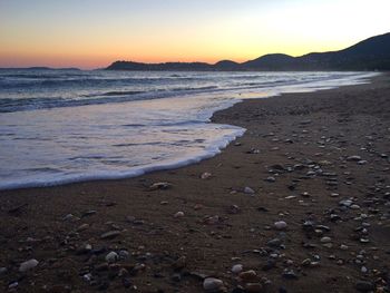 View of calm beach at sunset