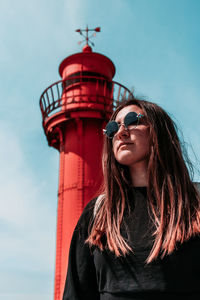 Portrait of woman in sunglasses against sky