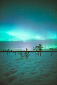 Scenic view of snow covered landscape against sky at night