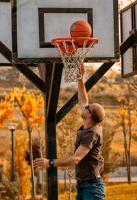 Man standing by basketball hoop