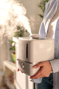 Close-up of woman holding humidifier