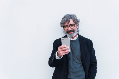 Portrait of businessman standing against white background
