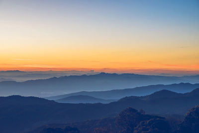 Scenic view of silhouette mountains against sky during sunset