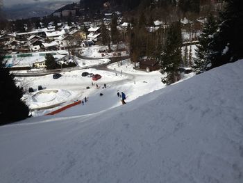 High angle view of people skiing on snow covered mountain