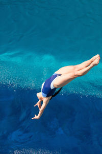 High angle view of woman jumping in swimming pool