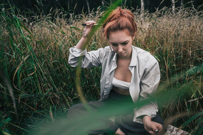 Young woman looking away on field