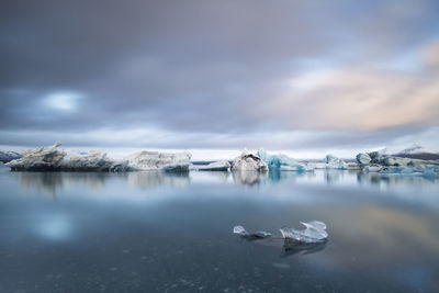 Scenic view of frozen lake against cloudy sky