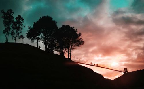 Low angle view of silhouette trees against sky at sunset