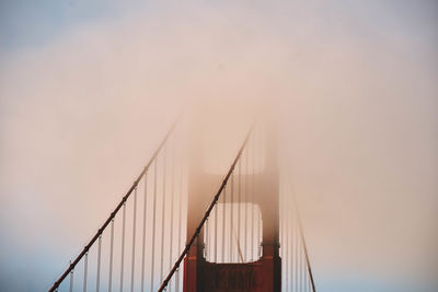 Golden gate bridge against sky during foggy weather