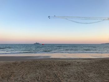 Scenic view of sea against clear sky during sunset