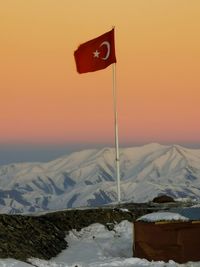 Scenic view of snow covered mountains against sky during sunset