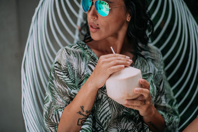 Midsection of a woman drinking glass