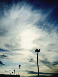 Low angle view of street light against cloudy sky