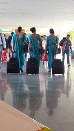 Group of people walking on wet floor